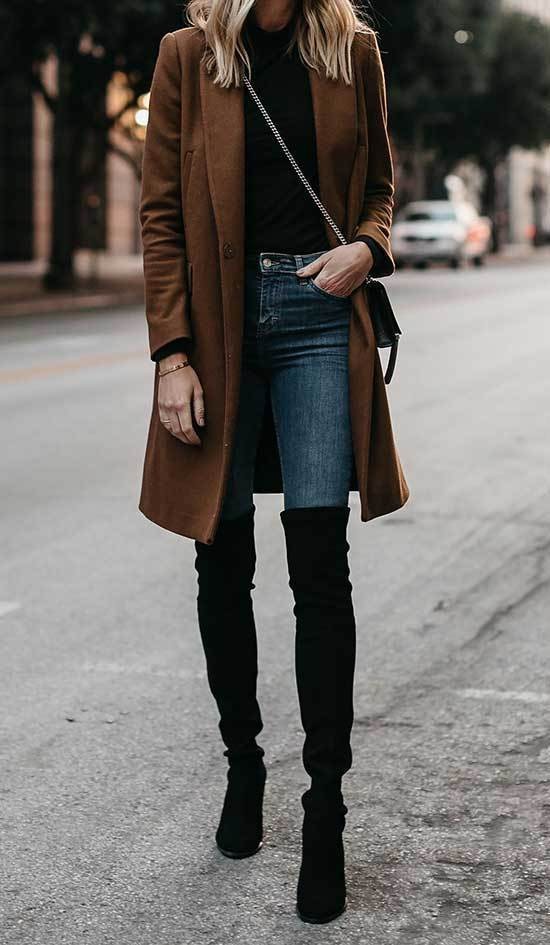 Ideas de atuendos de invierno con abrigo marrón, jeans azules y botas negras hasta la rodilla